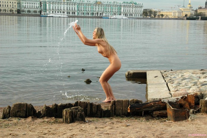 Naked woman on the embankment