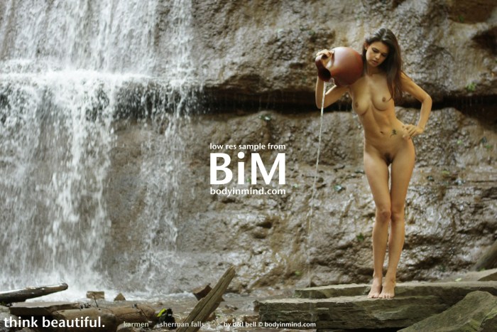 Naked woman near the waterfall