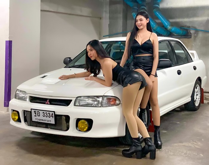 Girl sits by car