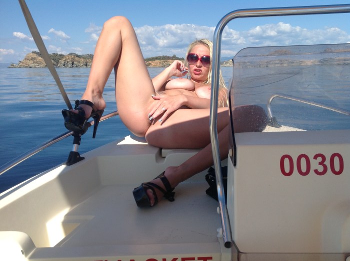 Naked with extended legs on a yacht