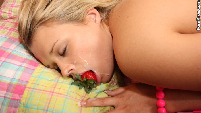Strawberry in a girl's pussy