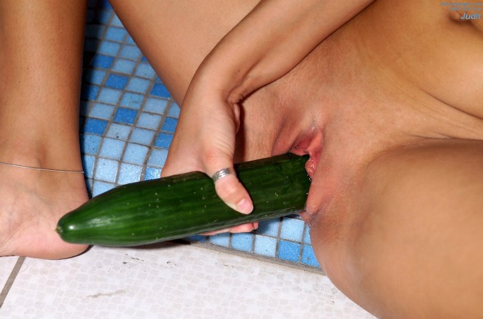 Girl with cucumber in shorts