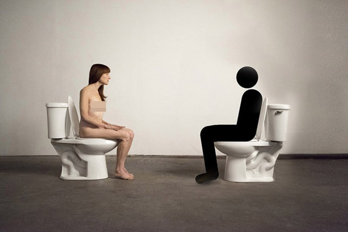 Naked posing in a chair