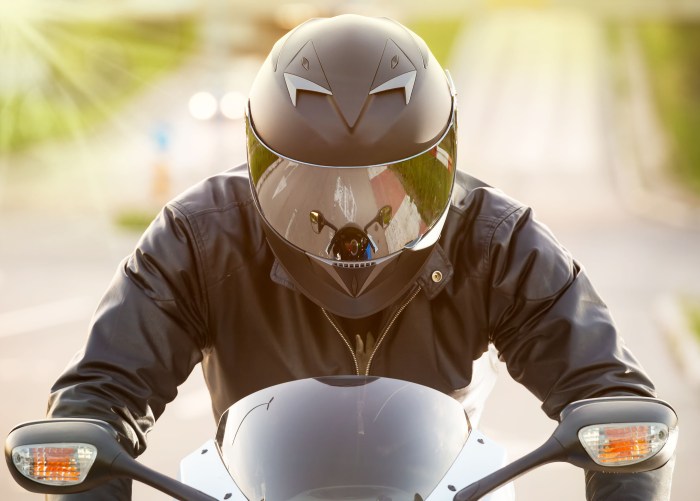 Girl on a motorcycle in a helmet