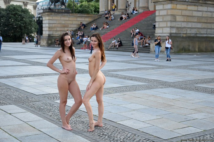 The girl undresses in a public place