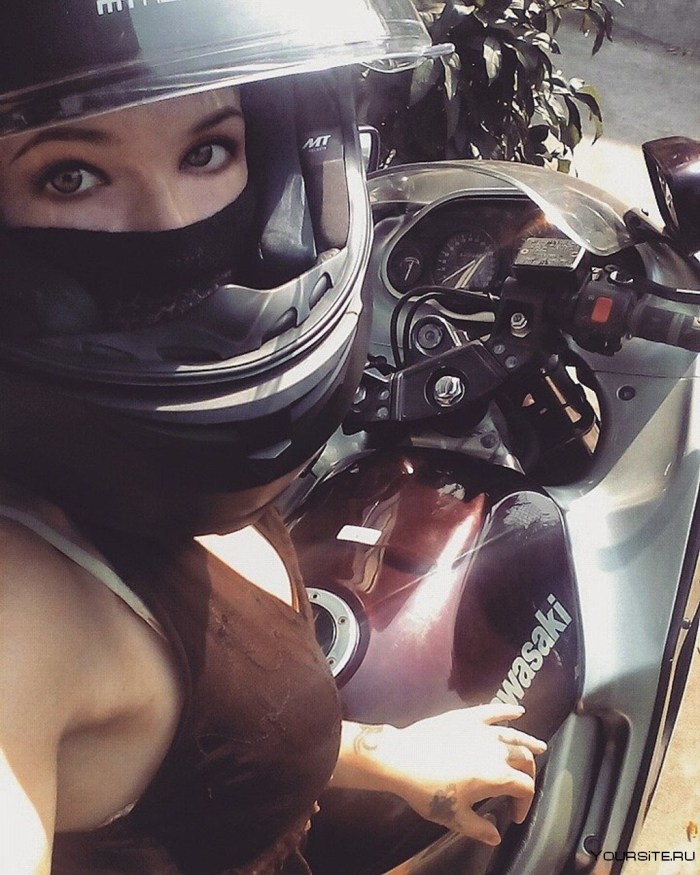 Girl on a motorcycle in a helmet