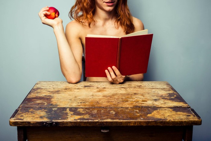 Naked woman reads a book