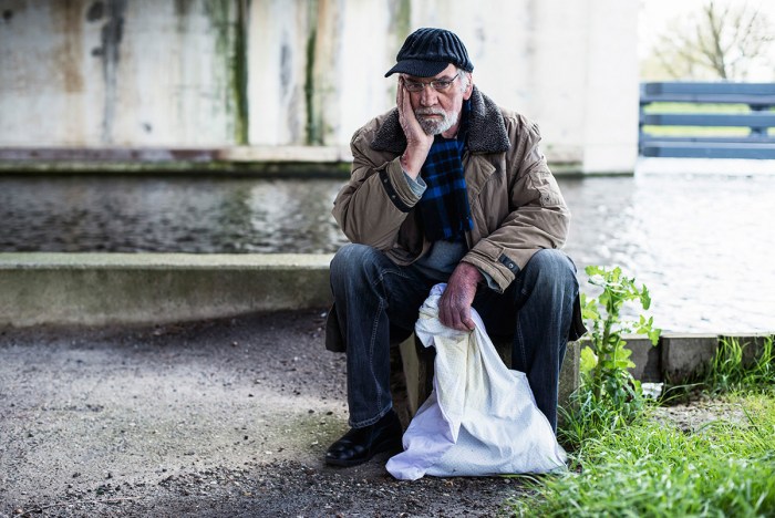 Homeless people with a sign