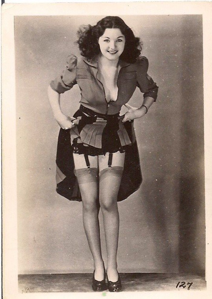 Margaret Nolan in stockings and belt