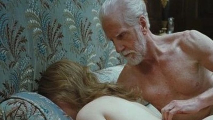 Old man and girl in bed