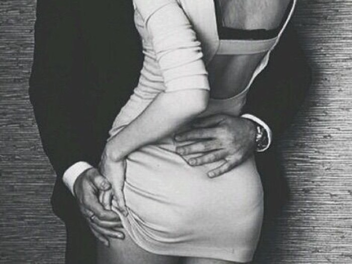 A man unfasten a dress for a woman
