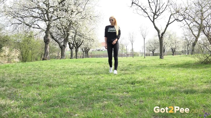 The girl pisses in the forest in winter