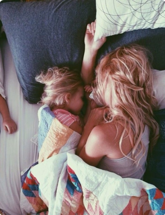Mother and daughter kiss