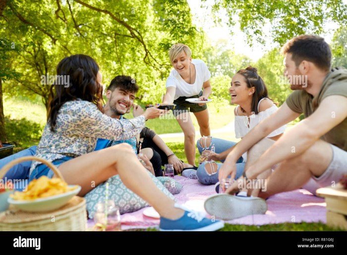 Photo of a group of people on a picnic where everyone is doing different things