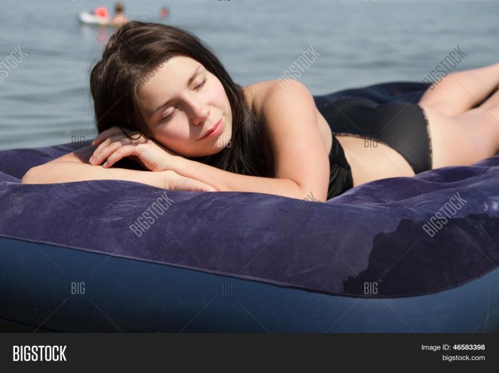 Girl on an inflatable mattress at sea