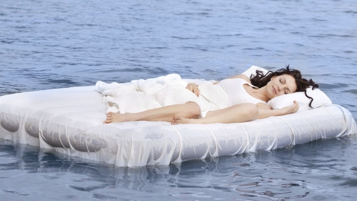 Girl on the mattress in the pool