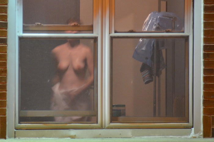 Peeping out the windows behind naked