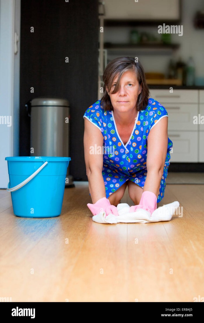 The woman washes the floor