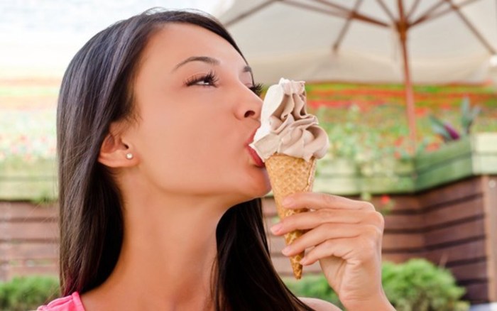 The girl licks ice cream