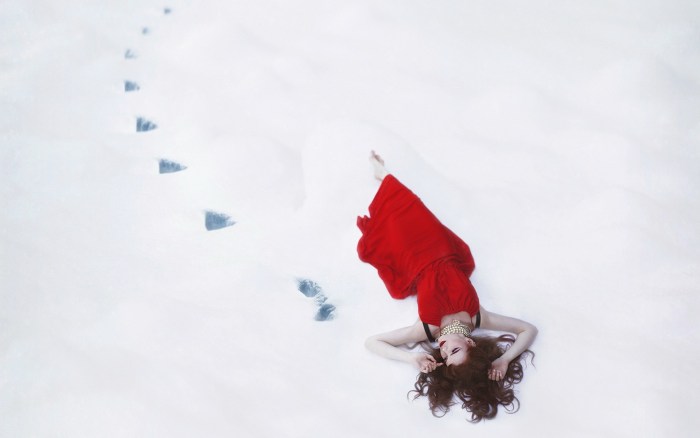 Girl in a red dress in the snow