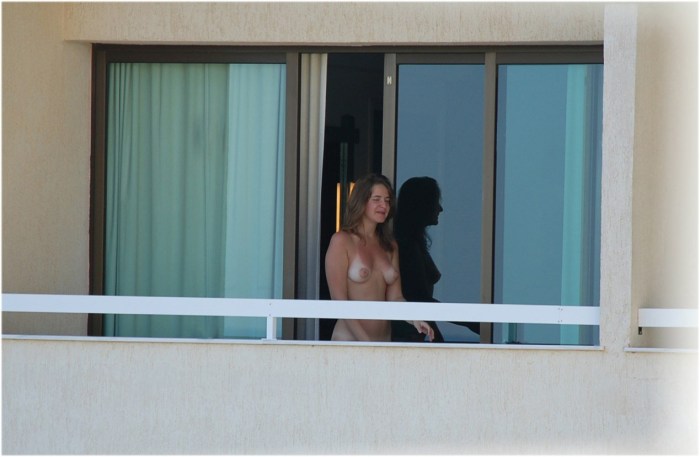 Naked woman near the window