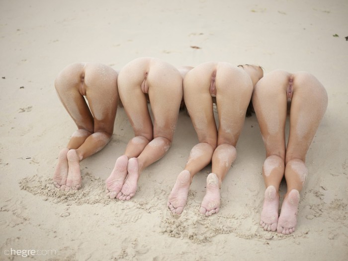 Naked female pop in the sand