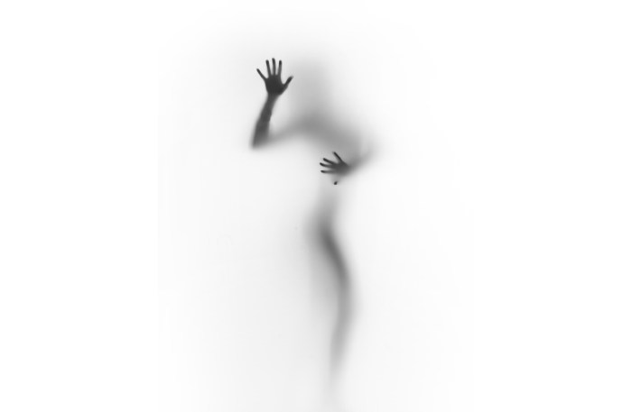 Silhouette behind matte glass