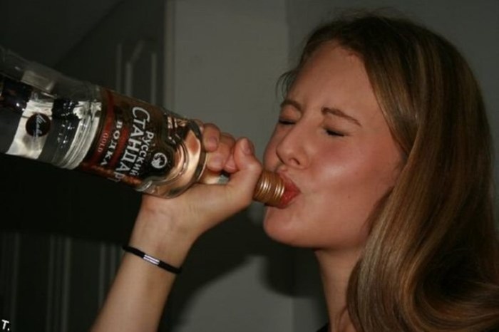 The girl drinks vodka