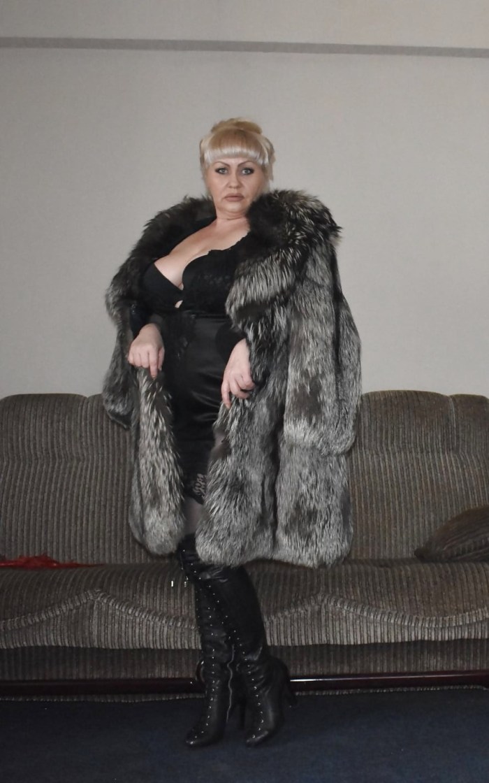 In a fur coat and underwear