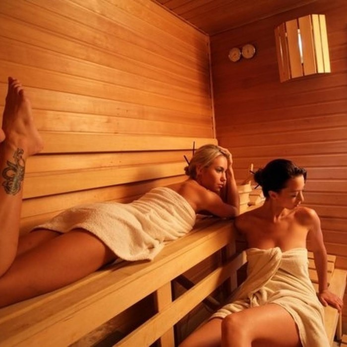 A guy with a girl in a sauna