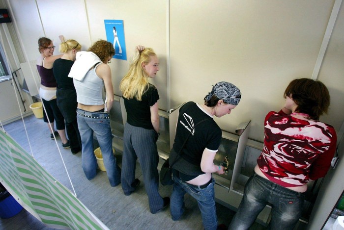 Girls piss on the side of the photo