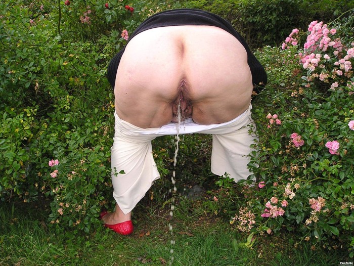 Old woman in the garden without panties
