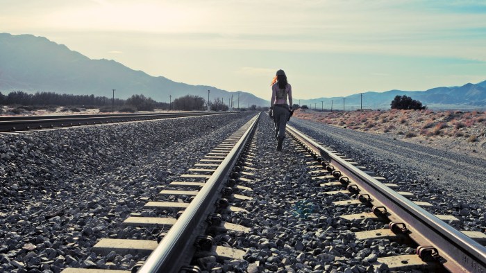 Girl on rails and train