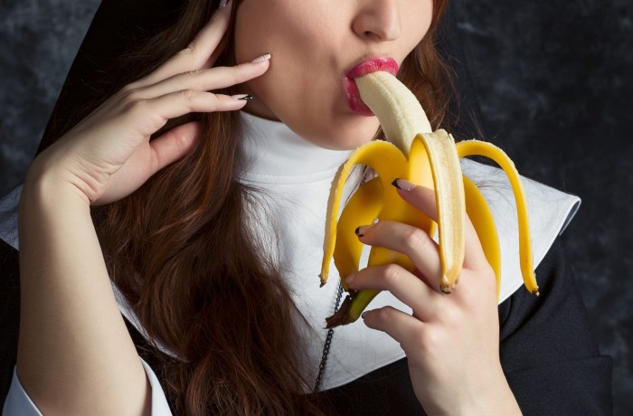 Girl with a banana in her mouth