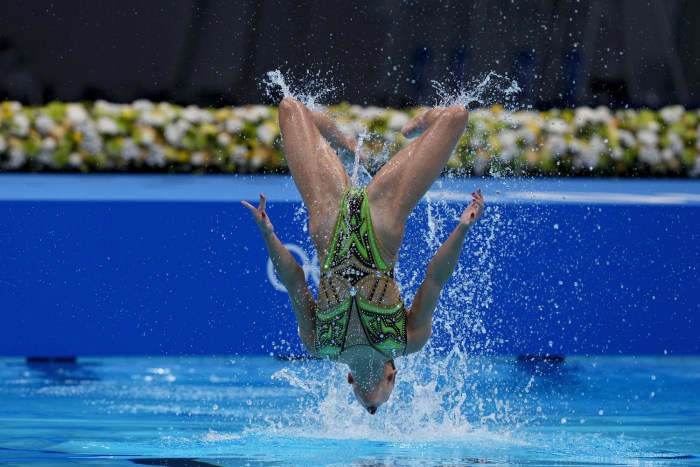 Synchronous swimming of a woman back view
