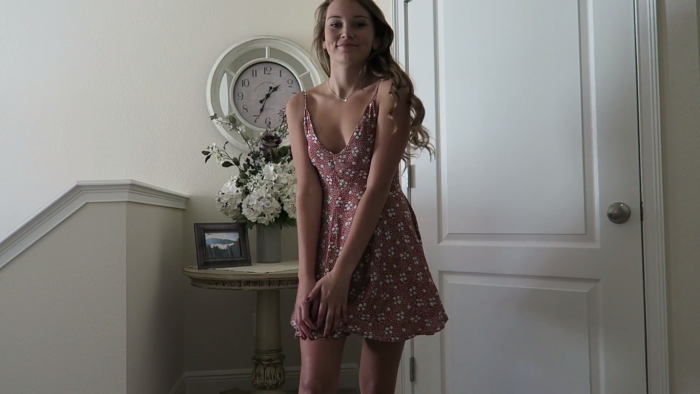 The girl puts on the dress