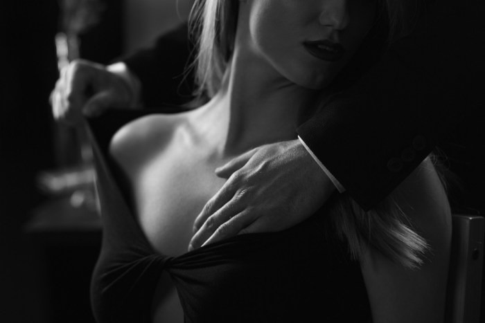 The man unfastens the dress