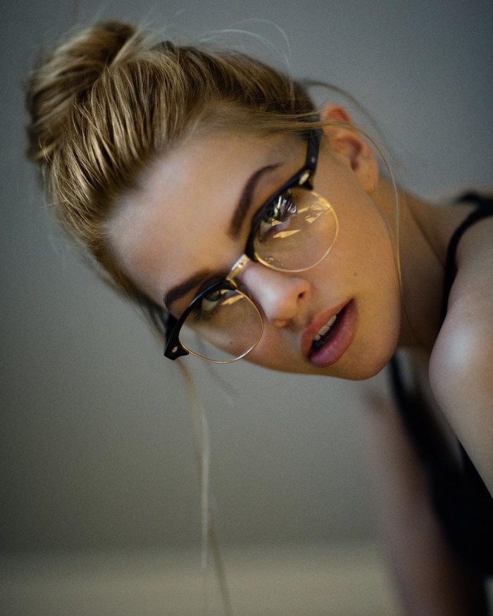 Cumshot on the face of a girl with glasses