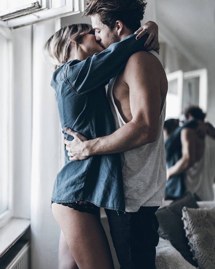 The guy hugs the girl behind