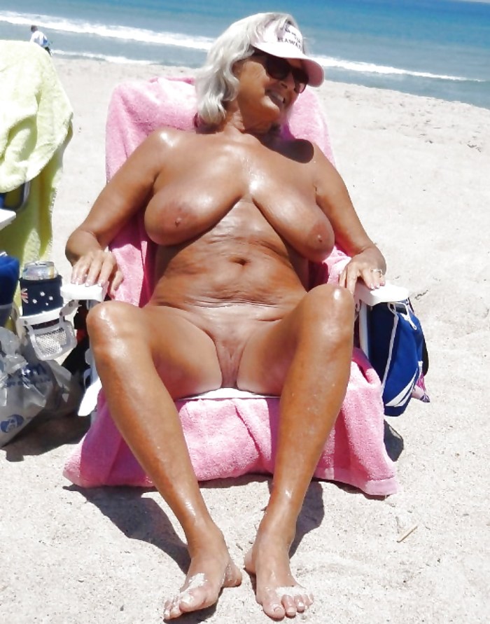 Old grandmother lit a tits on the beach