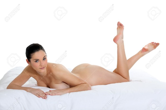 Naked young on a downy bed shows boobs