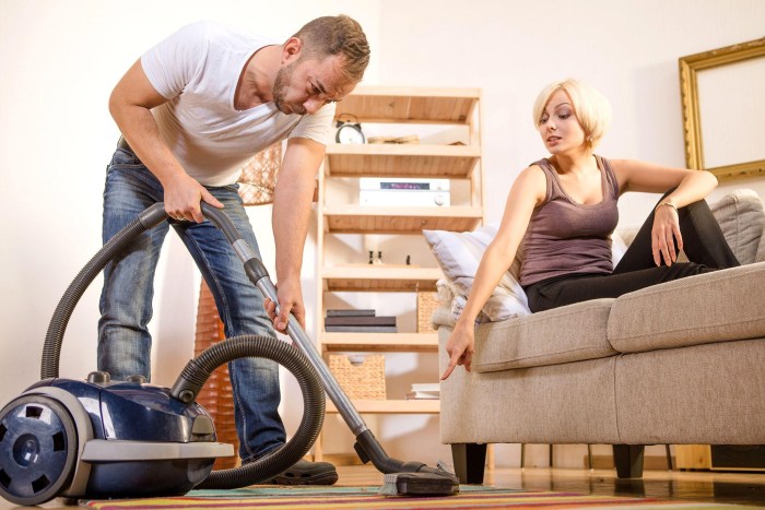 Vacuuming a woman and a man