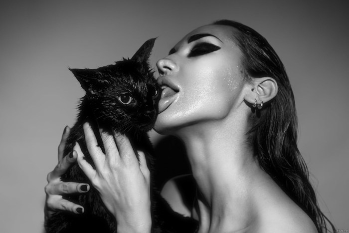 The girl licks the cat