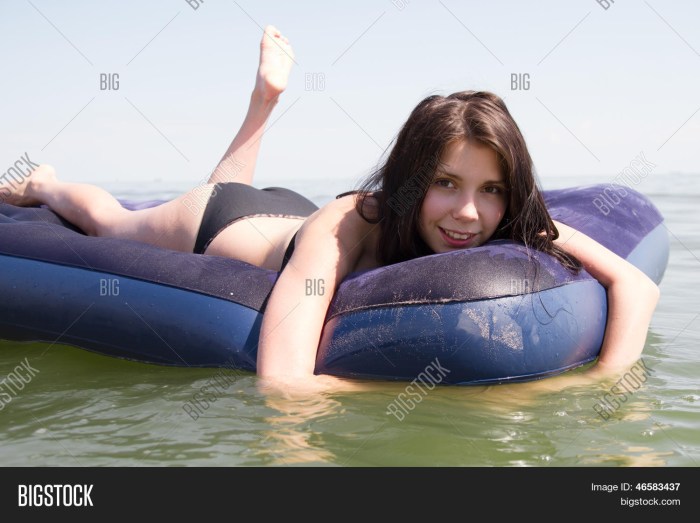 Girl on an inflatable mattress at sea