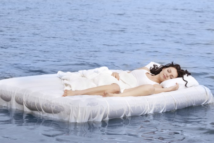 A man on a mattress in the pool