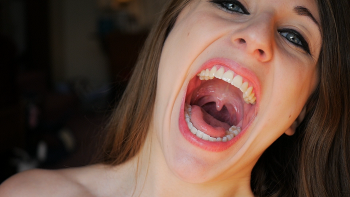 Girl with condom in her mouth