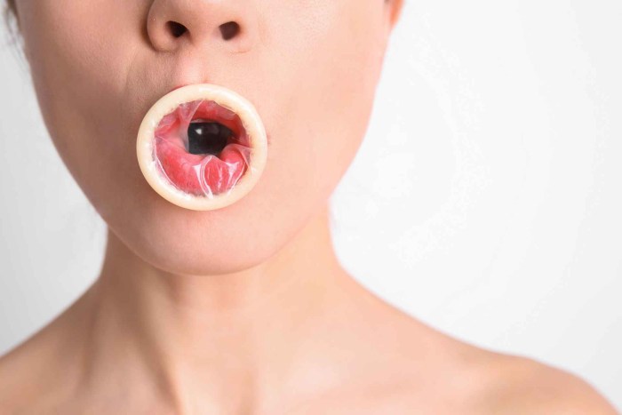 Girl with condom in her mouth