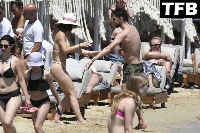 The girl sunbathes in thongs on the beach