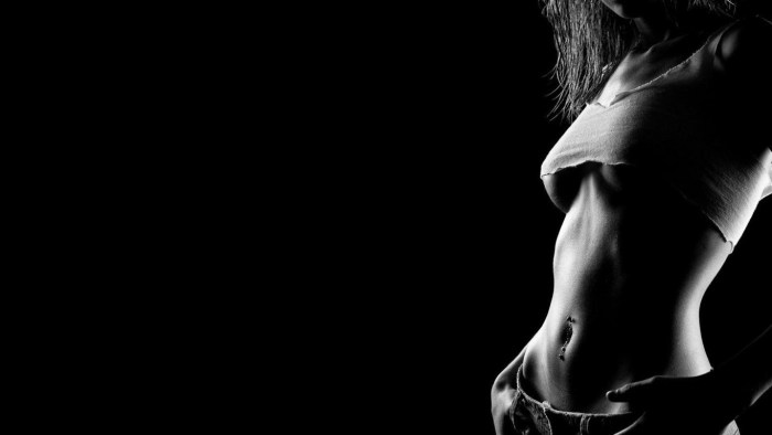Female body on a dark background