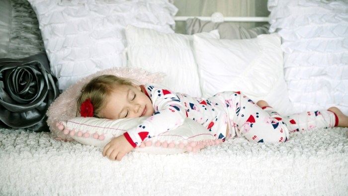 Girl in pajamas on the bed